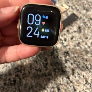 Used Fitbit Versa rose gold watch with new bands